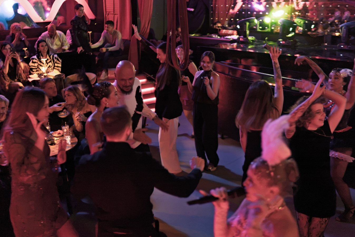 Guests and performers dancing together on the Stable 54 floor.