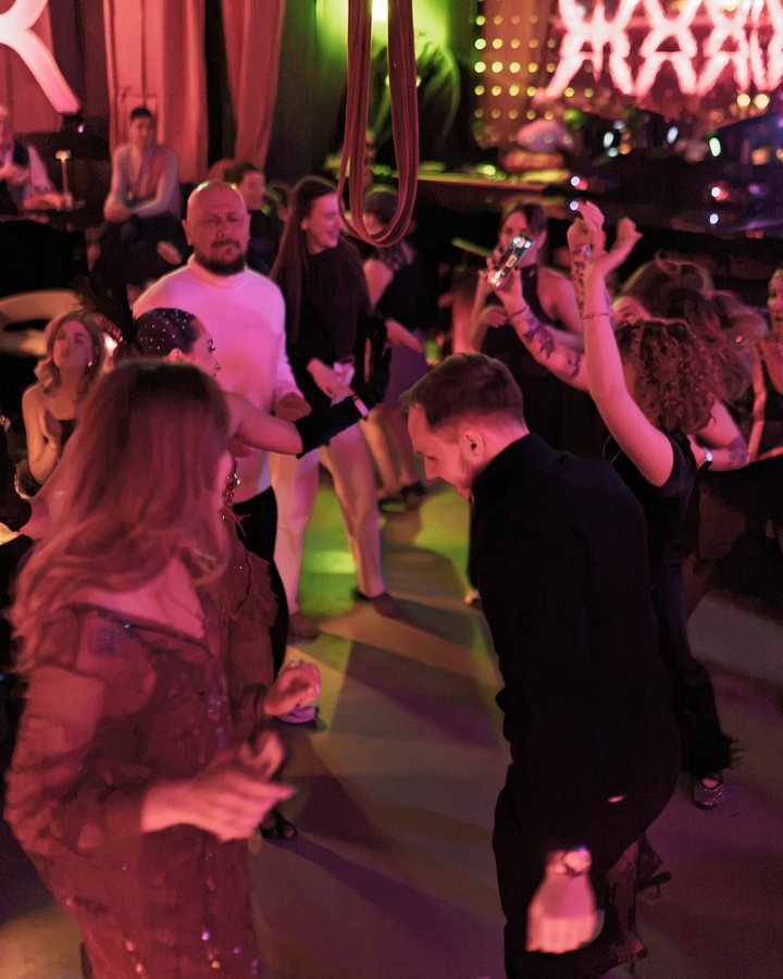 Guests dancing together on the Stable 54 floor.