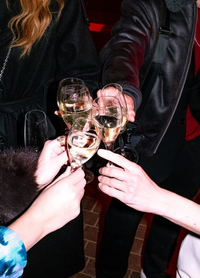 Guests clinking champagne glasses together.