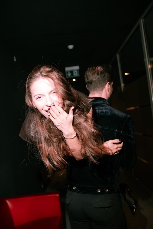 A laughing guest dancing in the hallway.