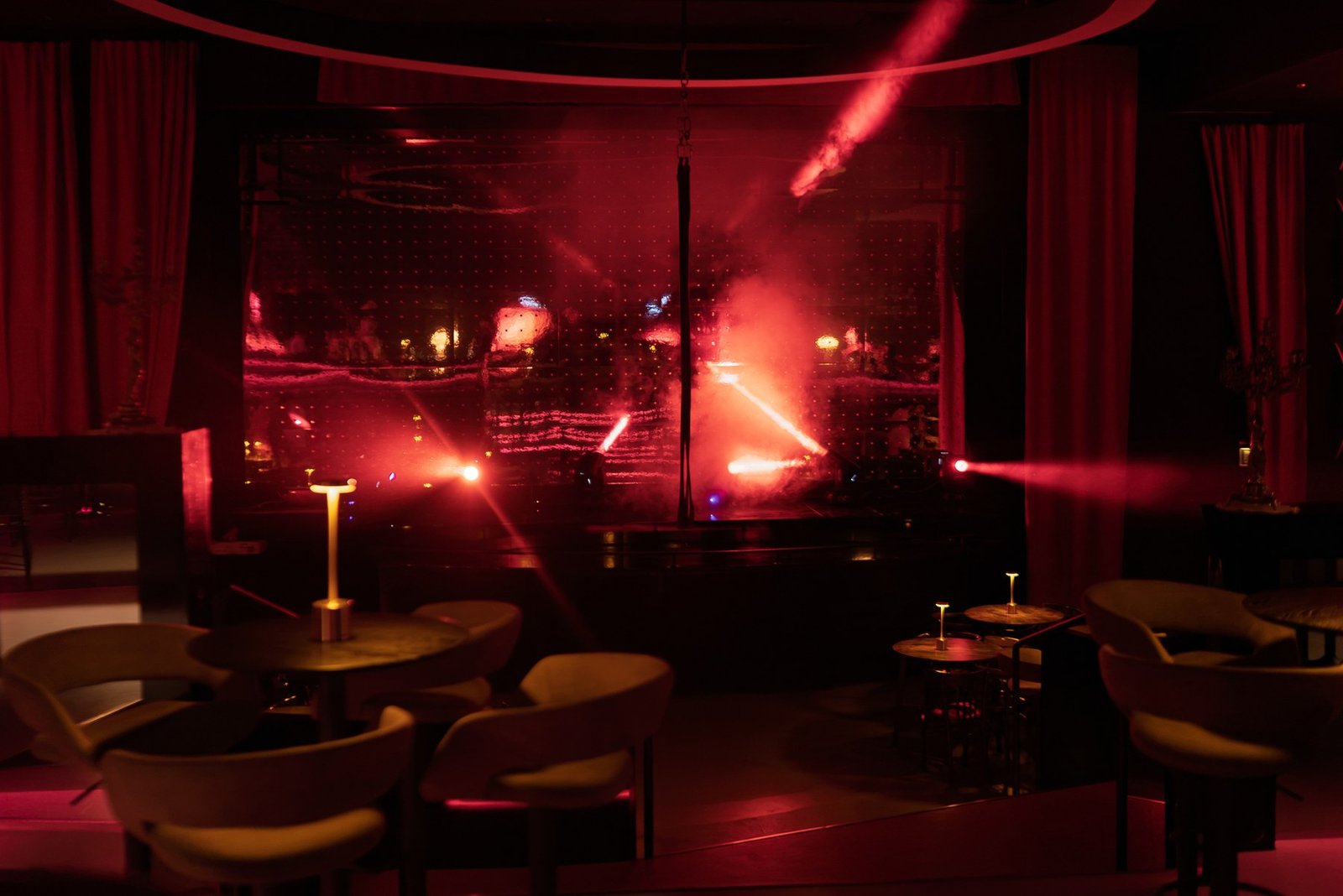 Red curtains, intimate tables and theatrical lighting around the Stable 54 stage.